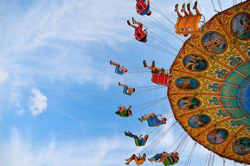 people people riding carnival ride under blue skies wallpaper